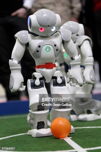Robots play football in a demonstration of artificial intelligence at the stand of the German Research Center for Artificial Intelligence at the...