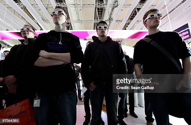 Visitors watch a 3D presentation at the Deutsche Telekom stand at the CeBIT Technology Fair on March 2, 2010 in Hannover, Germany. CeBIT will be open...