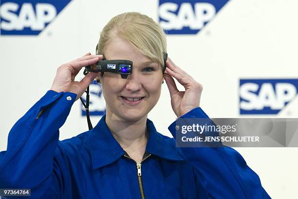 An employee of German software giant SAP presents a "Head-Mounted Display" at the CeBit 2010 exhibition, the world's biggest high-tech fair in...