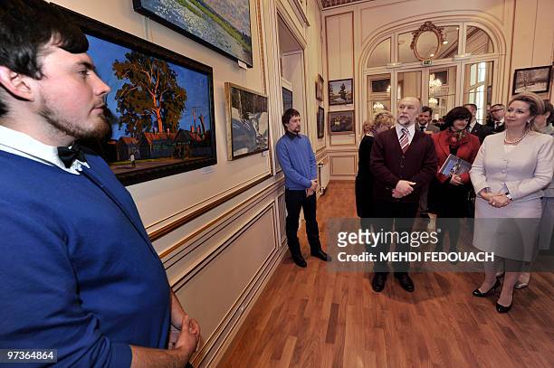 Russian first lady Svetlana Medvedeva looks at a painting as she visits the exhibition called "A window to Russia" on March 2, 2010 at the Russian...