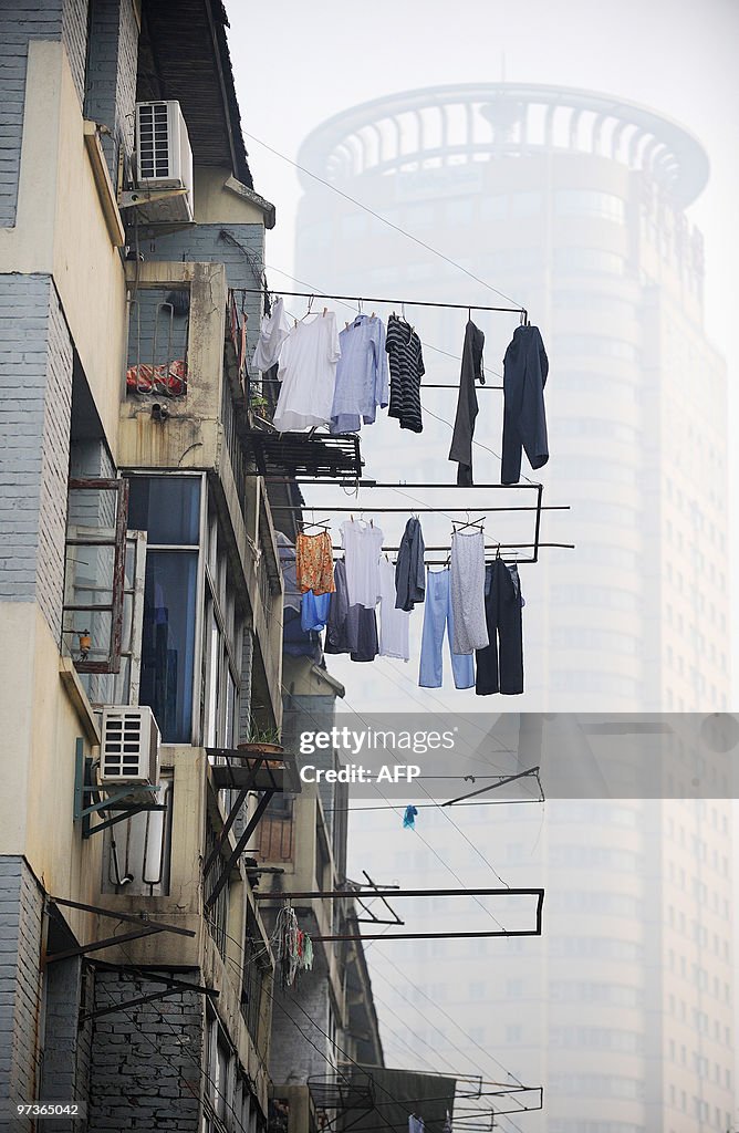 Laundry hangs from the window of a build
