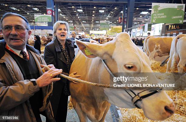 French Junior Minister for Family and Solidarity Nadine Morano pets a cow as she visits on March 2, 2010 the international agricultural fair to be...