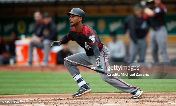 Jarrod Dyson of the Arizona Diamondbacks bunts during the game against the Oakland Athletics at the Oakland Alameda Coliseum on May 26, 2018 in...