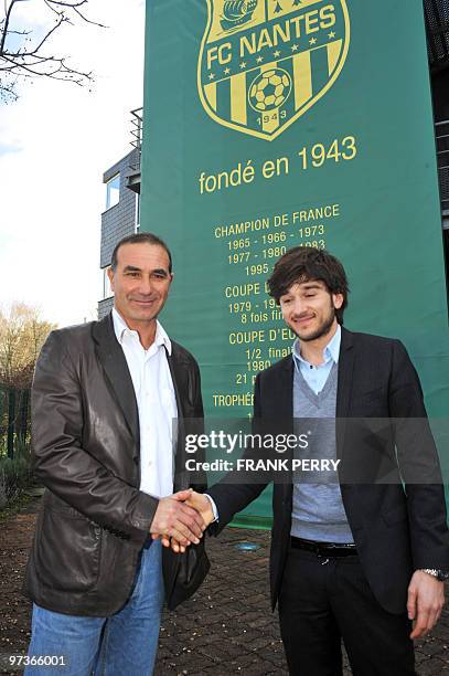 New coach of French L 2, football team FC Nantes, Baptiste Gentili shakes hand with the club temporary President Franck Kita , son of the club's...