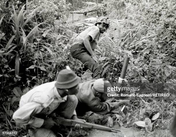 Africa, Nigeria civil war, Biafra, soldiers shooting with a mortar in the bushes.