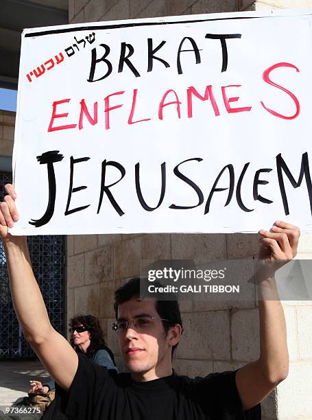 Israeli left-wing activists from the Peace Now movement protest against Jerusalem's Mayor Nir Barkat outside the city council during a press...