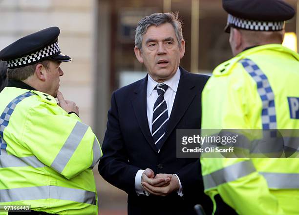 British Prime Minister Gordon Brown speaks to police officers before delivering a speech in Reading Town Hall on March 1, 2010 in Reading, England....
