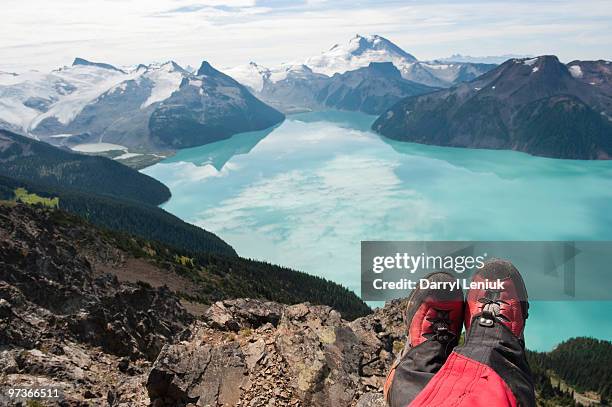 man's hiking boots over mountain lake - wonderlust2015 stock pictures, royalty-free photos & images