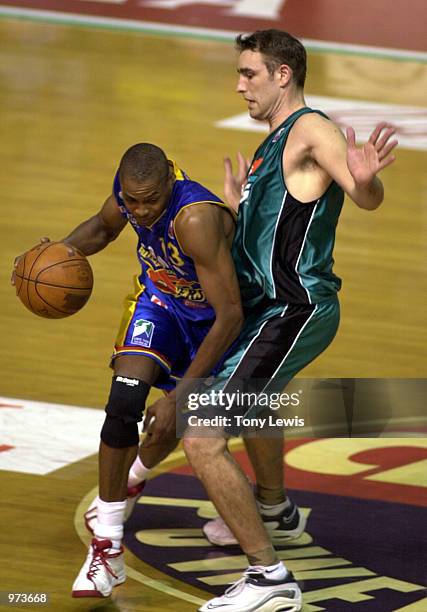 Darnell Mee for Adelaide gets past Jason Smith for Melbourne in the match between the Adelaide 36ers and the Melbourne Titans played at the Clipsal...