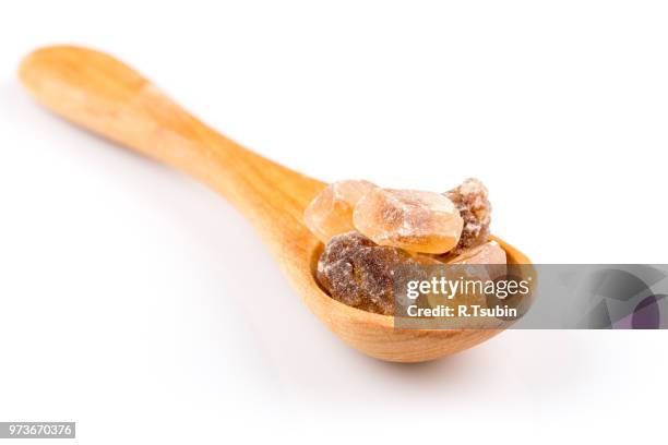 brown caramelized sugar in a wooden spoon on a white background - hyperglycemia stock pictures, royalty-free photos & images