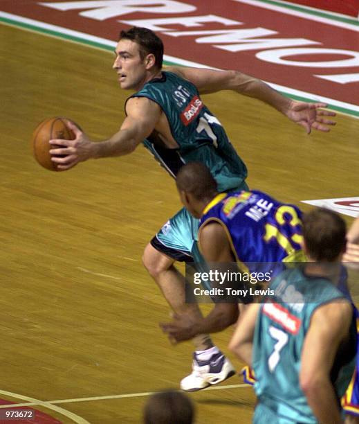 Jason Smith for Melbourne leaves Darnell Mee for Adelaide in his wake in the match between the Adelaide 36ers and the Melbourne Titans played at the...