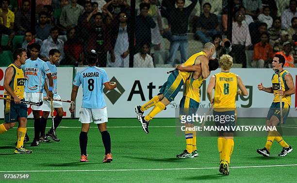 Australian hockey players celebrate their fifth goal against India during their World Cup 2010 match at the Major Dhyan Chand Stadium in New Delhi on...