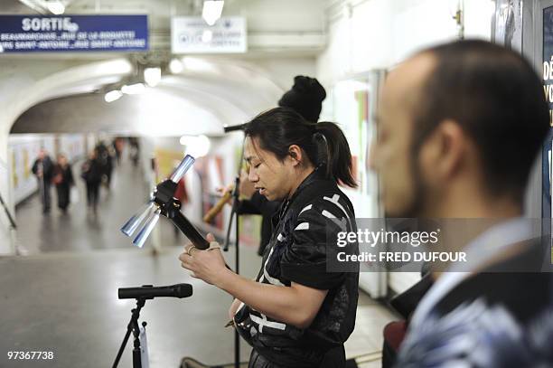 Japanese Tsugaru Shamisen player Keisho Ohno performs in Paris' subway on February 26 to promote this northern Japan traditional music. AFP PHOTO /...