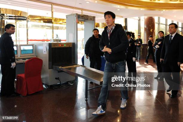 Olympic hurdle champion Liu Xiang arrives at a hotel to attend the annual session of the 11th National Committee of the Chinese People's Political...