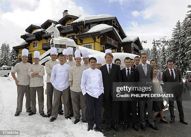 Philippe Gourgaud , manager of the restaurant "Cheval blanc" and French chef Denis Fetisson pose on February 26 along with other cooks, in front of...