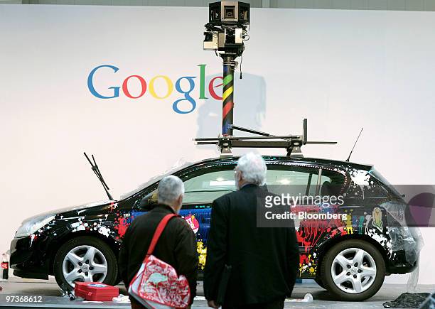 Visitors look at a Google street view car on display at the CeBIT technology fair in Hanover, Germany, on Tuesday, March 2, 2010. Makers of software,...