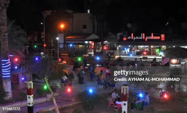 General view shows an outdoors coffee shop in Hafez al-Assad square, named after the late Syrian president and the father of the current ruler, in...