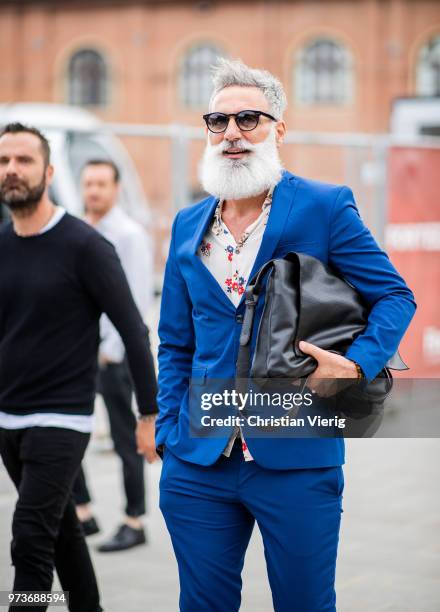 Guest wearing a white beard is seen during the 94th Pitti Immagine Uomo on June 13, 2018 in Florence, Italy.