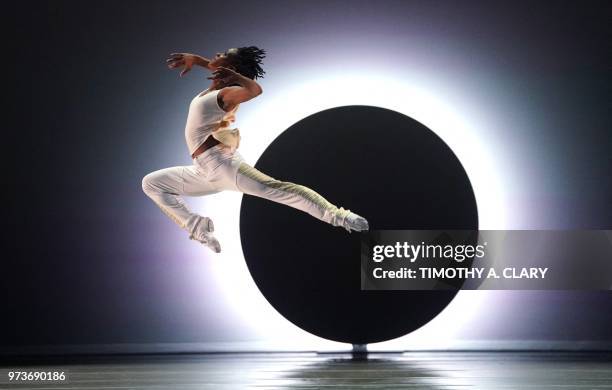 Dancers with the Alvin Ailey American Dance Theater perform a scene from the World Premier of "EN" during a dress rehearsal June 13 before opening...