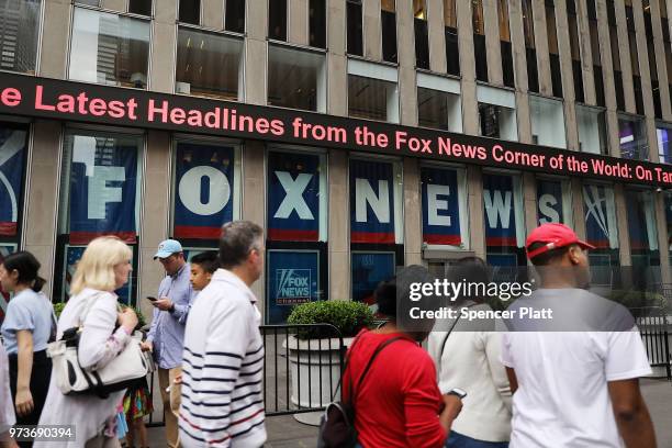 People walk by the headquarters of 21st Century Fox on June 13, 2018 in New York City. Comcast, the giant cable operator, on Wednesday officially...