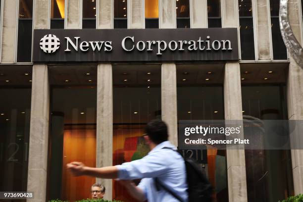 People walk by the headquarters of 21st Century Fox on June 13, 2018 in New York City. Comcast, the giant cable operator, on Wednesday officially...