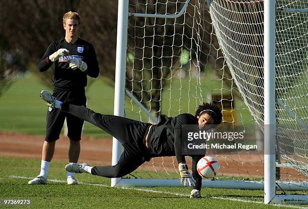David James makes a save as Joe Hart looks on during an England training session at London Colney on March 2, 2010 in St Albans, England.