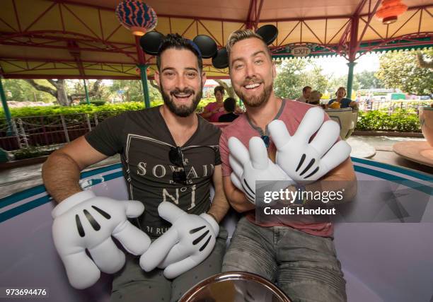 In this handout image provided by Walt Disney World Resort, Lance Bass and husband Michael Turchin take a teacup for a colorful spin at the Mad Tea...
