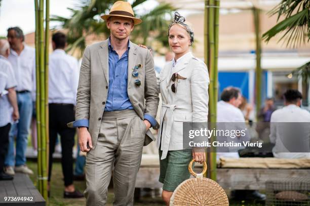 Couple Roman Zaczkiewicz wearing khaki sarfari linen suit Zack Roman, chambray button down shirt, cuffed two pleats linen trousers, panama hat, blue...