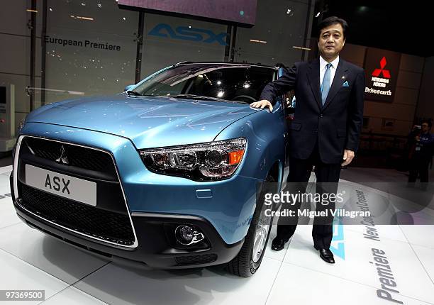 Mitsubishi Motors Corporation President Osamu Masuko poses next to a ASX car during the first press day at the 80th Geneva International Motor Show...