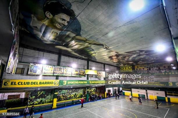 Young players practice at Sportivo Pereyra de Barracas Club on June 13, 2018 in Buenos Aires, Argentina. The mural was painted in the ceiling of the...