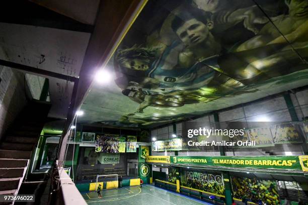 Kids play in the 5-a-side pitch of Sportivo Pereyra de Barracas club on June 13, 2018 in Buenos Aires, Argentina. The mural was painted in the...