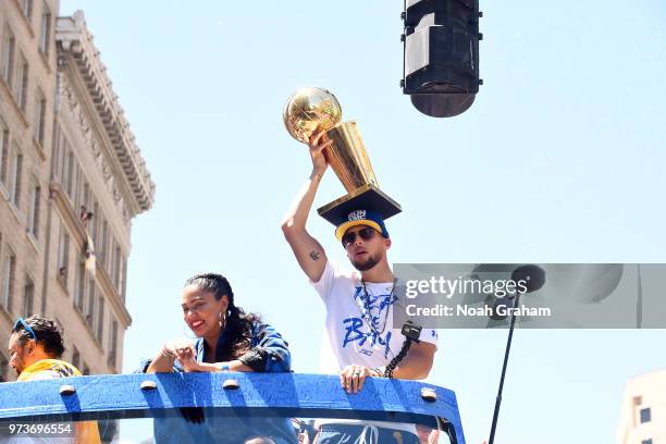 Stephen Curry of the Golden State Warriors holds up the Larry O'Brien Championship Trophy during the Golden State Warriors Victory Parade on June 12,...