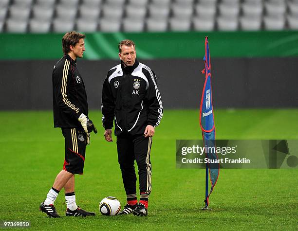 Rene Adler and goal keeper trainer Andreas Koepke are seen during a training session for the German national football team at the Allianz Arena on...