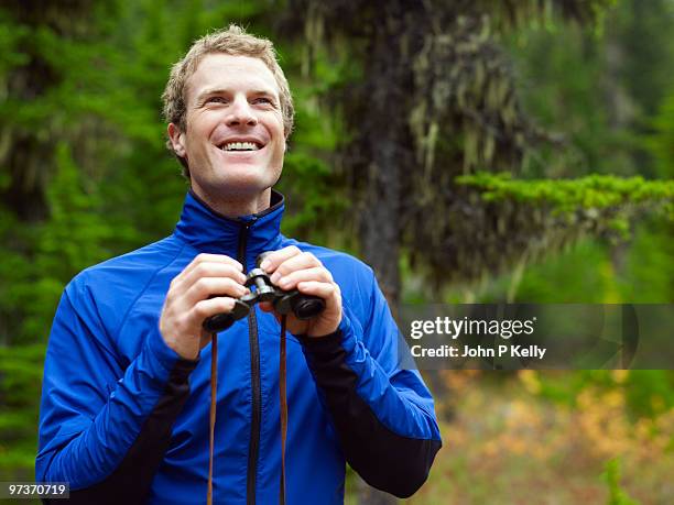 man holding binoculars - john p kelly stock pictures, royalty-free photos & images