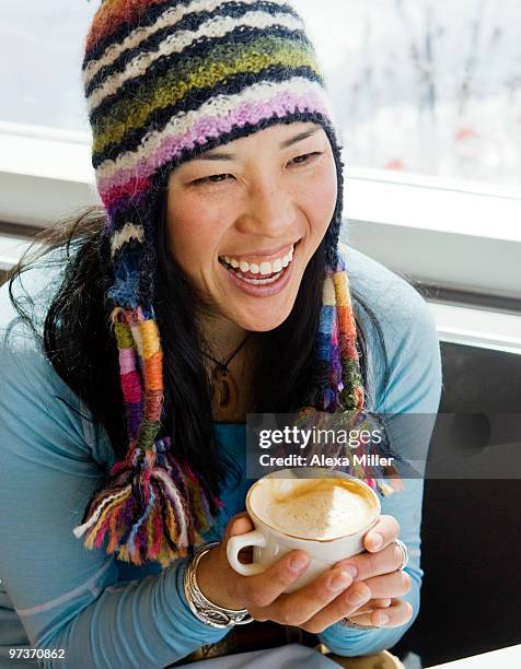 portrait of a young woman drinking a latte - alta stock-fotos und bilder