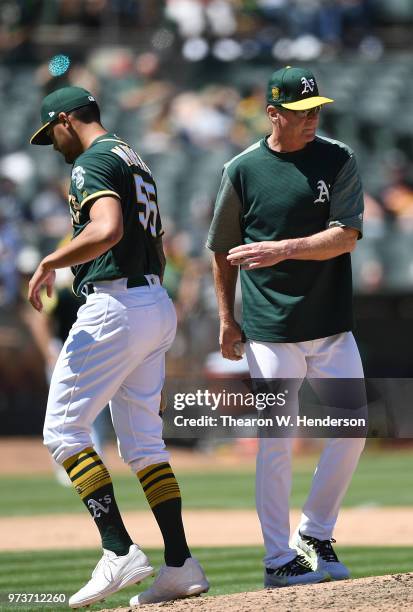 Manager Bob Melvin of the Oakland Athletics takes the ball from starting pitcher Sean Manaea taking Manaea out of the game against the Kansas City...