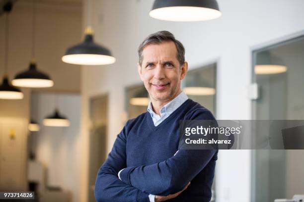 confident mature businessman in office - enterprise stock pictures, royalty-free photos & images