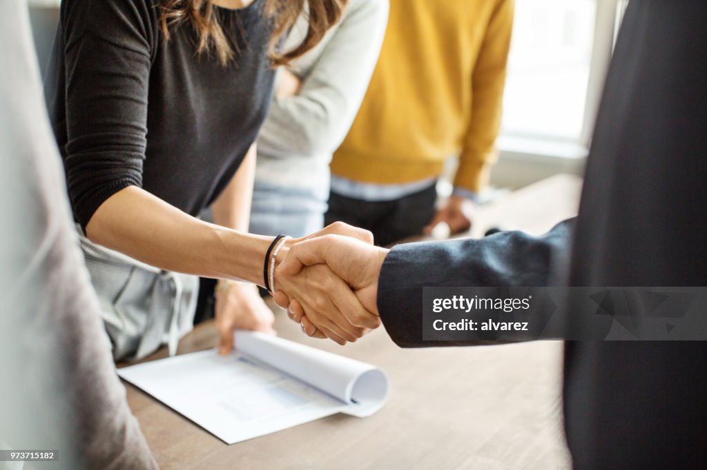 Business people shaking hands in office