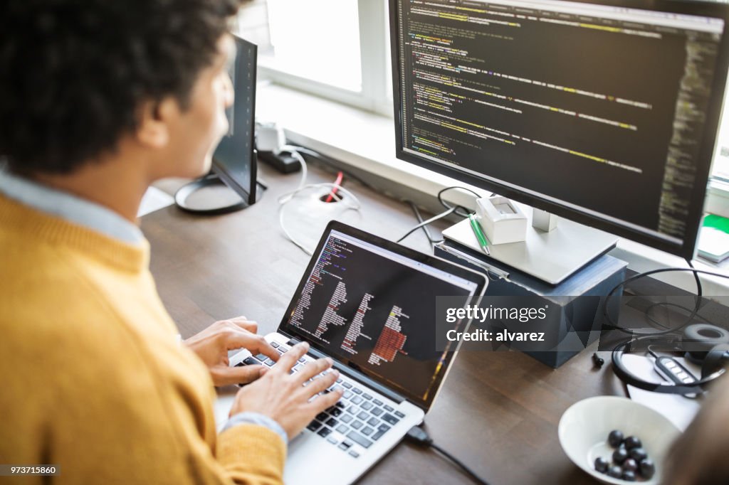 Computer programmer working at his desk