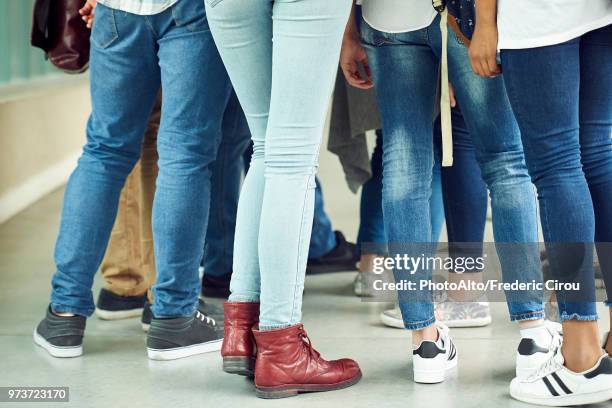 students standing in corridor, low section - vaqueros ajustados fotografías e imágenes de stock