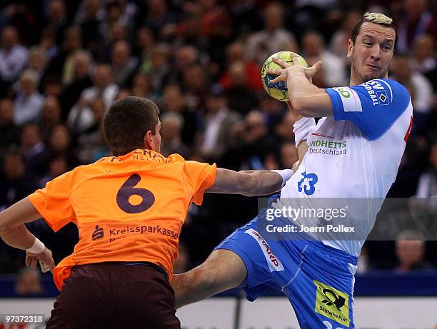 Pascal Hens of Hamburg and Drago Vukovic of Gummersbach compete for the ball during the Bundesliga match between HSV Hamburg and VfL Gummersbach at...