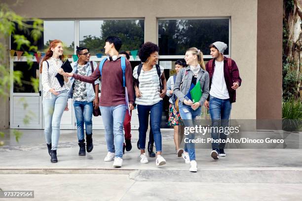 classmates walking and chatting together on college campus - leaving school imagens e fotografias de stock