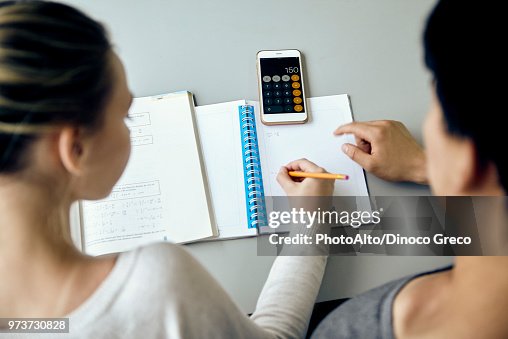 Students working together on mathematics assignment Students working together on mathematics assignment