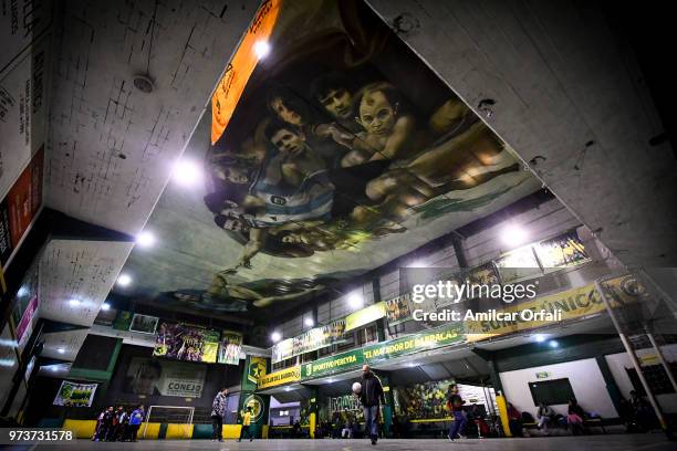 Young players practice at Sportivo Pereyra de Barracas Club on June 13, 2018 in Buenos Aires, Argentina. The mural was painted in the ceiling of the...