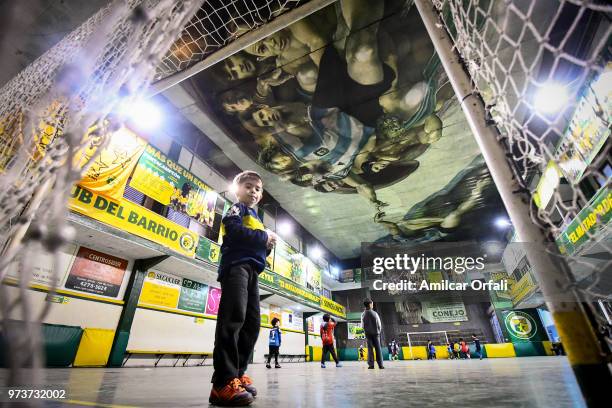 Young player guards the net at Sportivo Pereyra de Barracas club on June 13, 2018 in Buenos Aires, Argentina. The mural was painted in the ceiling of...