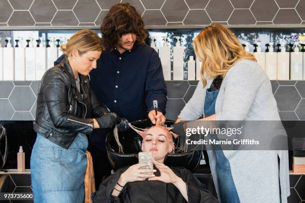 a male hairdresser giving instructions - wash bowl fotografías e imágenes de stock