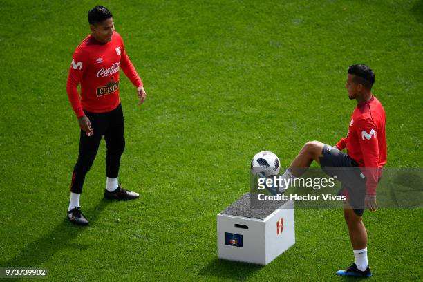 Raul Ruidiaz and Miguel Trauco of Peru make the ball bounce on the plinth during a training session at Arena Khimki on June 12, 2018 in Khimki,...