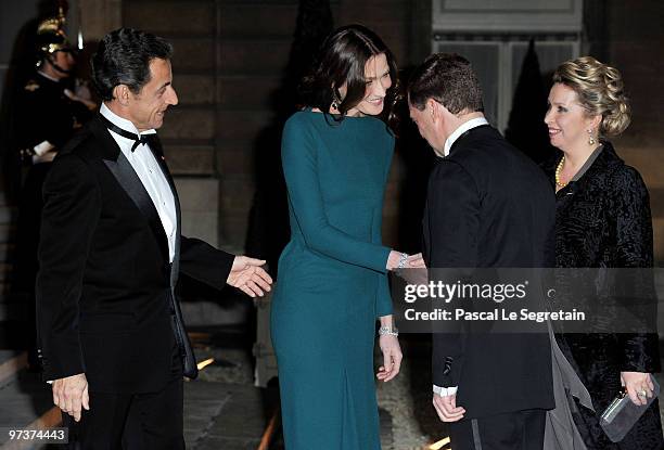 French President Nicolas Sarkozy and his wife Carla Bruni-Sarkozy greet Russian President Dmitry Medvedev and his wife Svetlana Medvedeva as they...