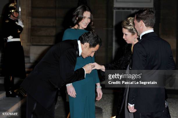 French President Nicolas Sarkozy and his wife Carla Bruni-Sarkozy greet Russian President Dmitry Medvedev and his wife Svetlana Medvedeva as they...