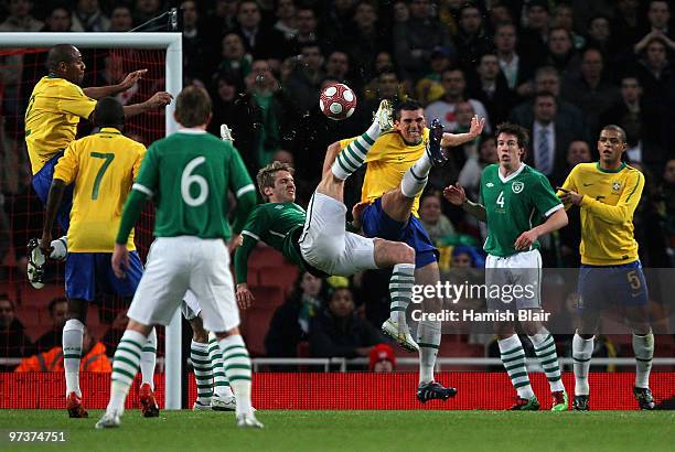 Kevin Doyle of Ireland has an unsuccessful attempt on goal under pressure from Lucio of Brazil during the International Friendly match between...